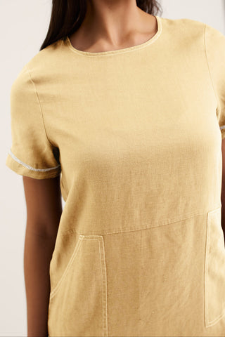 Yellow dress with short sleeves and a pocket on a plain background